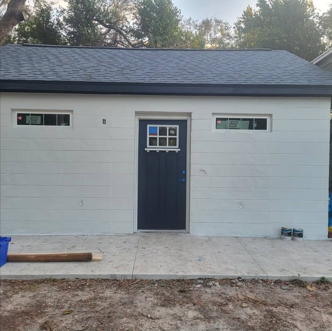 Garage painted white with navy door